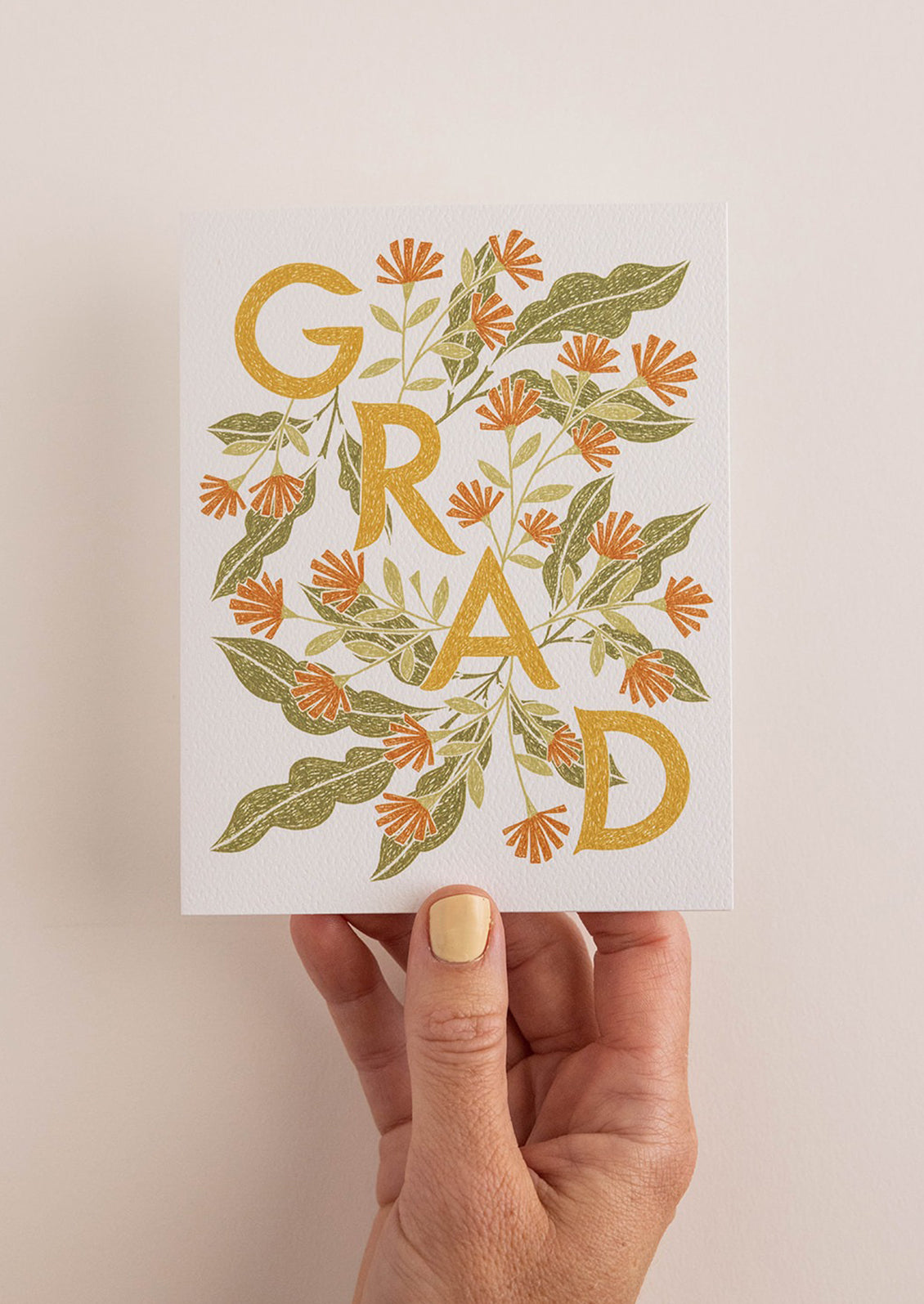 A floral print card reading "GRAD".