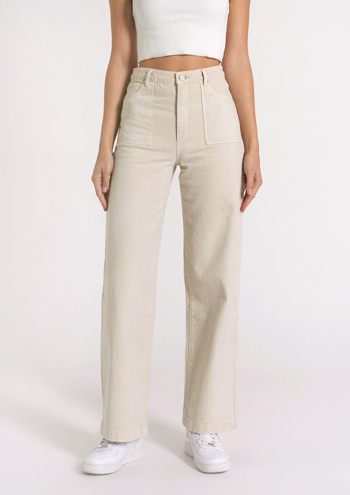 Cream colored denim jeans with high rise and front patch pockets.