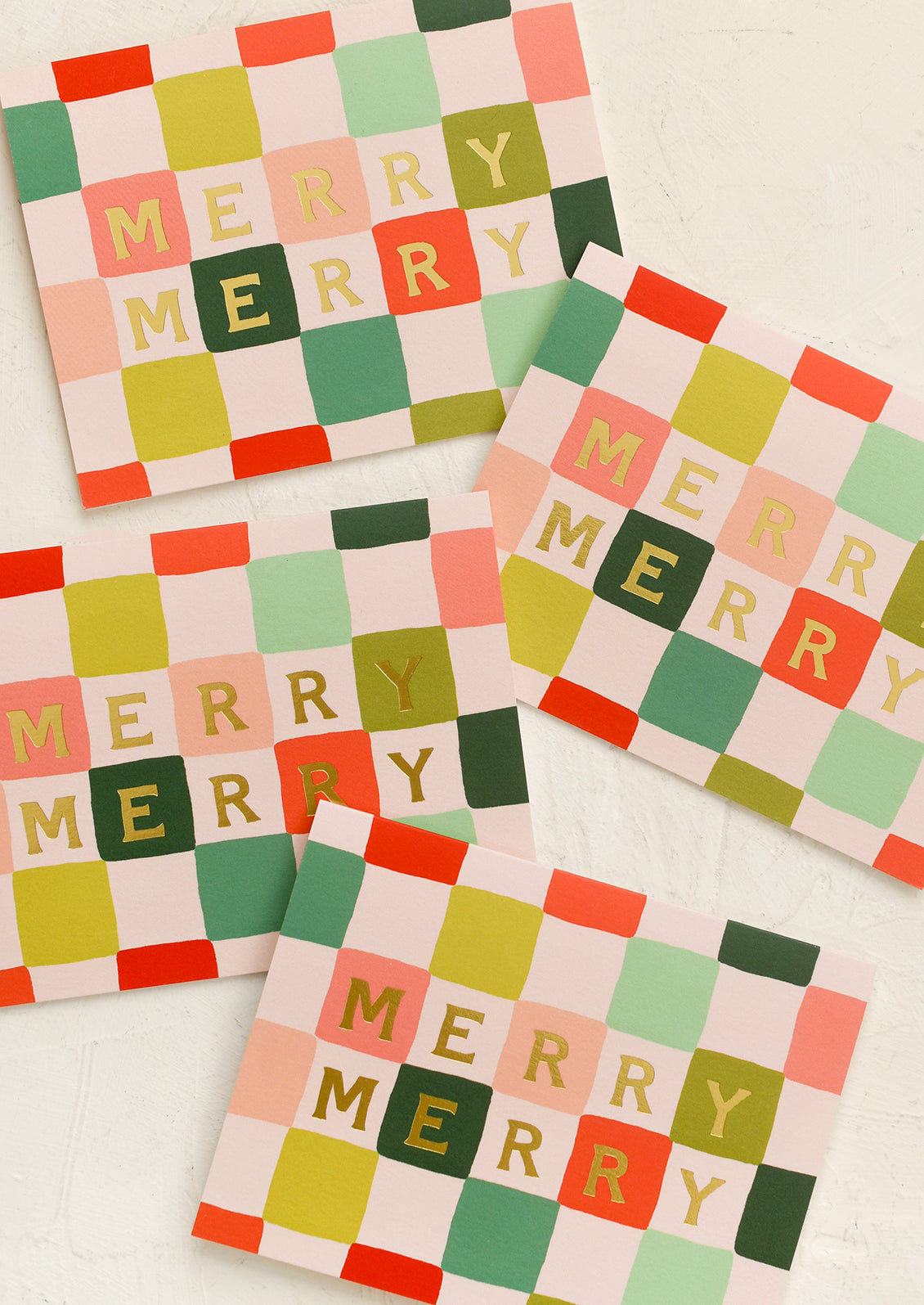 A set of red and green checkerboard print cards, gold lettering reads "Merry Merry".