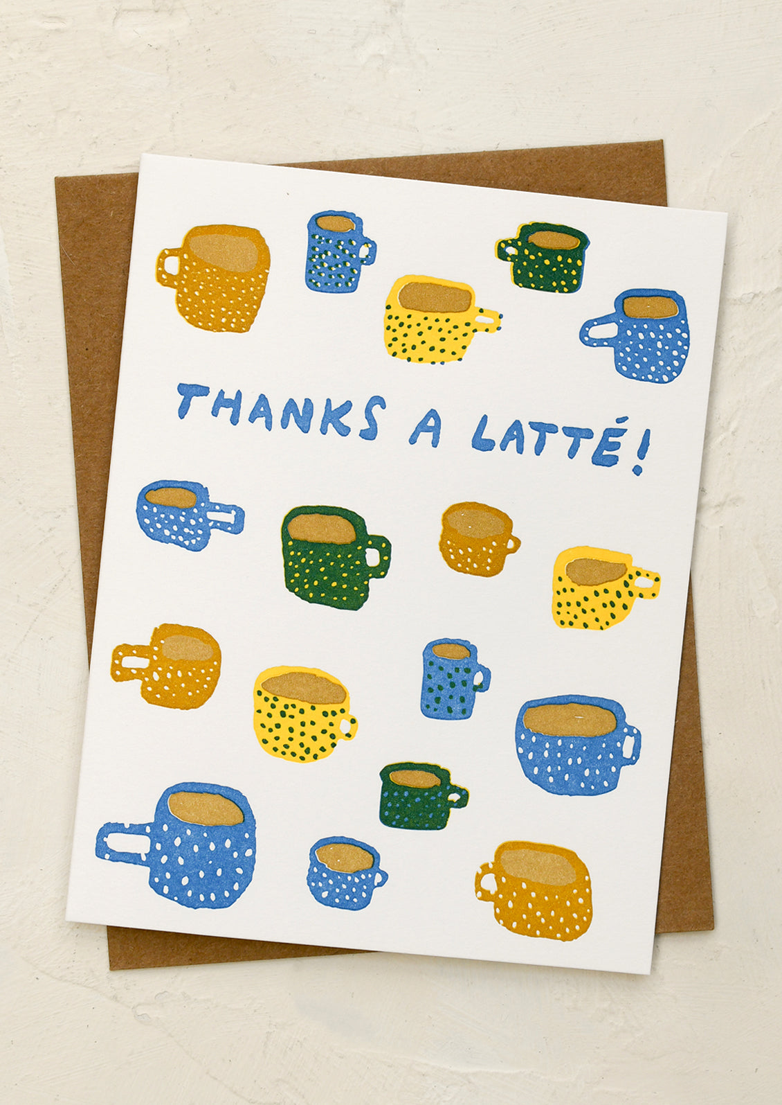 A card with illustration of coffee mugs, text reads "Thanks a latte!".