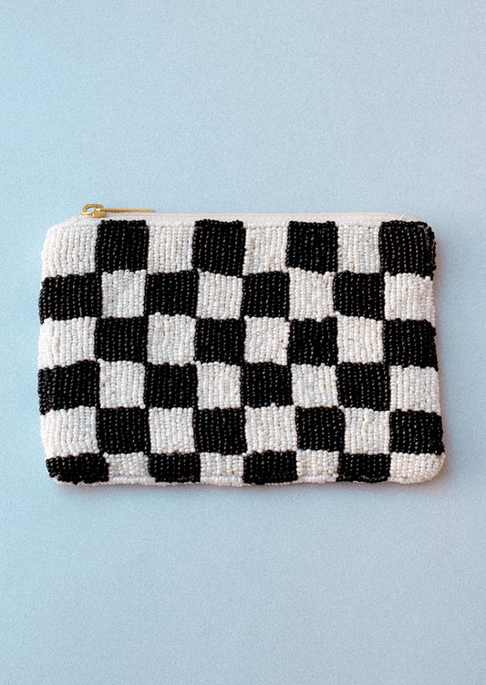 A rectangular coin pouch in black and white checker print.