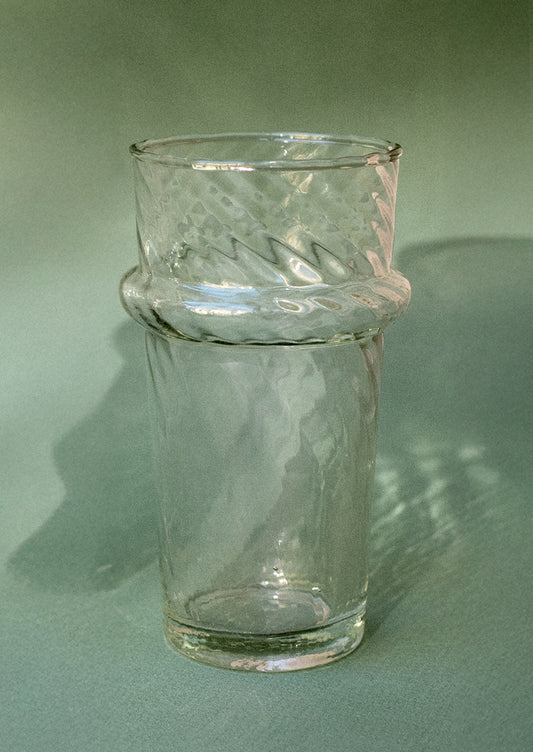 A clear recycled glass tumbler in swirl glass texture.