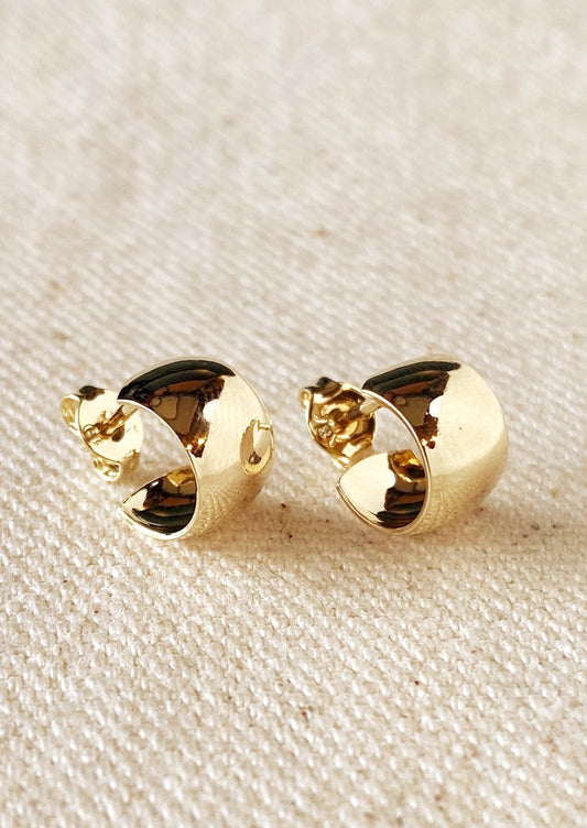 A pair of wide and thick chunky mini hoop earrings with post back in gold.