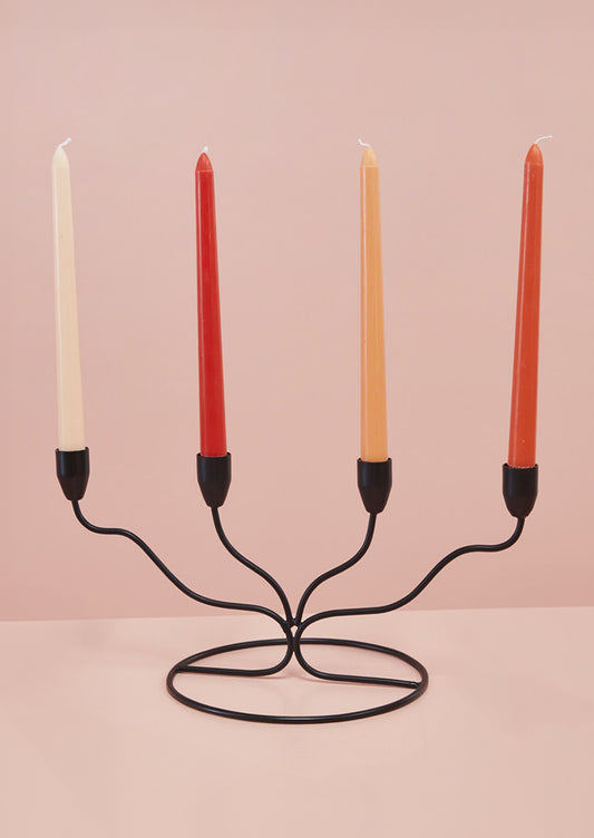 A black metal candleholder in modern, curved shape.