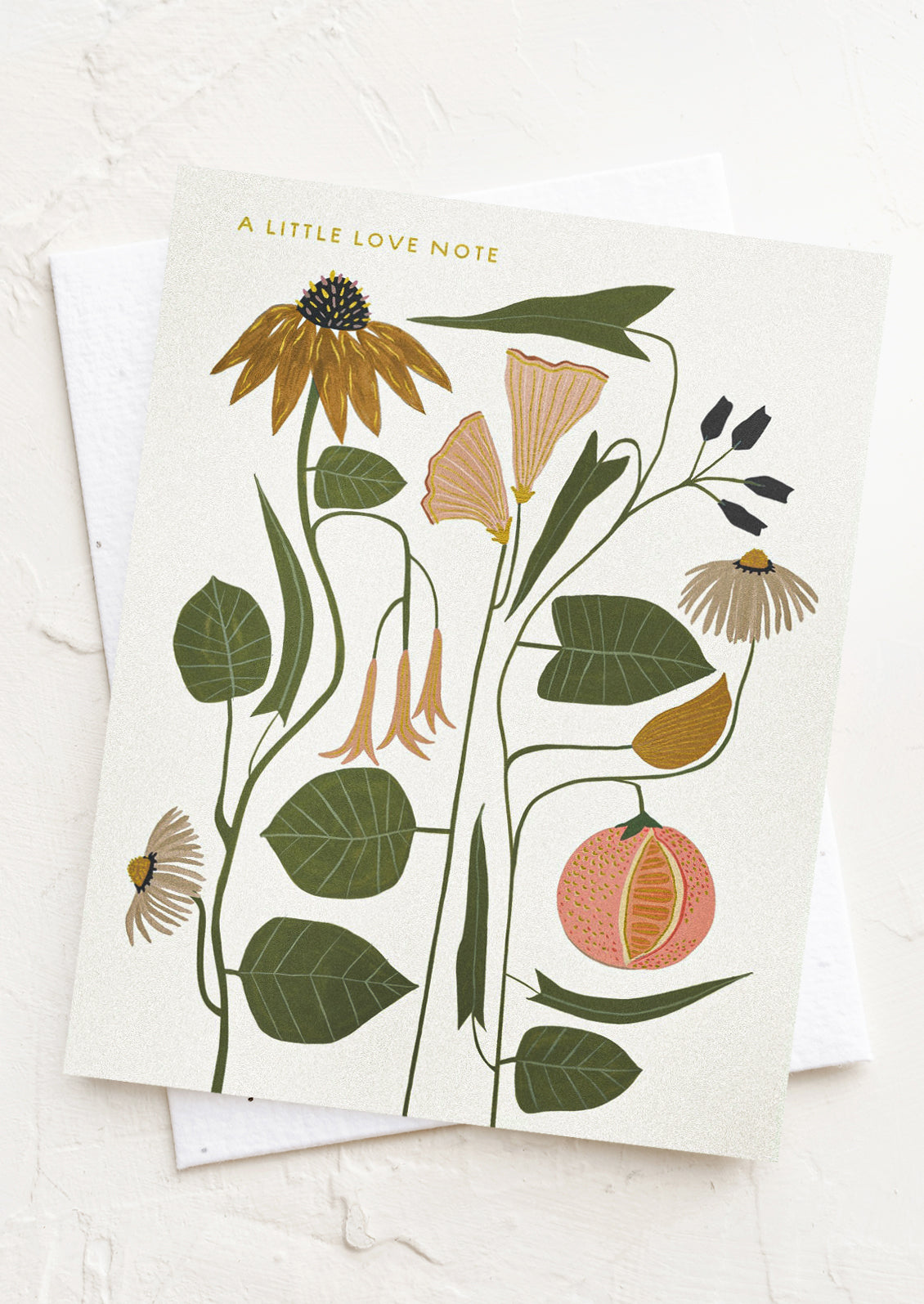 A floral print card with gold text reading "A little love note".