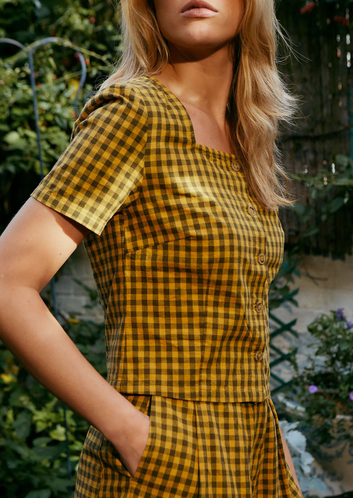 A short sleeve, square neck top in mustard and brown gingham.