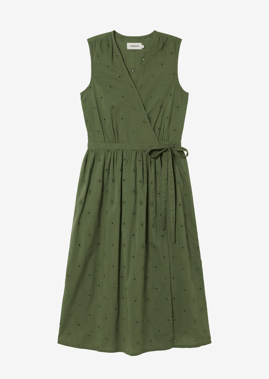 Green cotton dress with tie closure and sun-shaped eyelet embroidery.