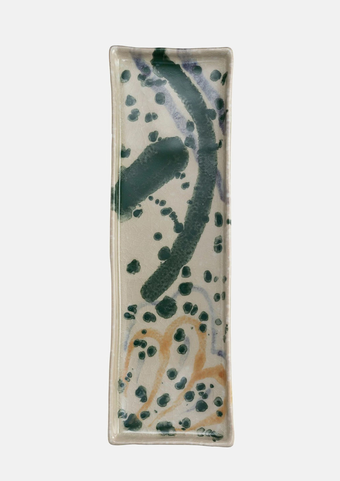 Long rectangular ceramic tray with multicolor paint splatter pattern.