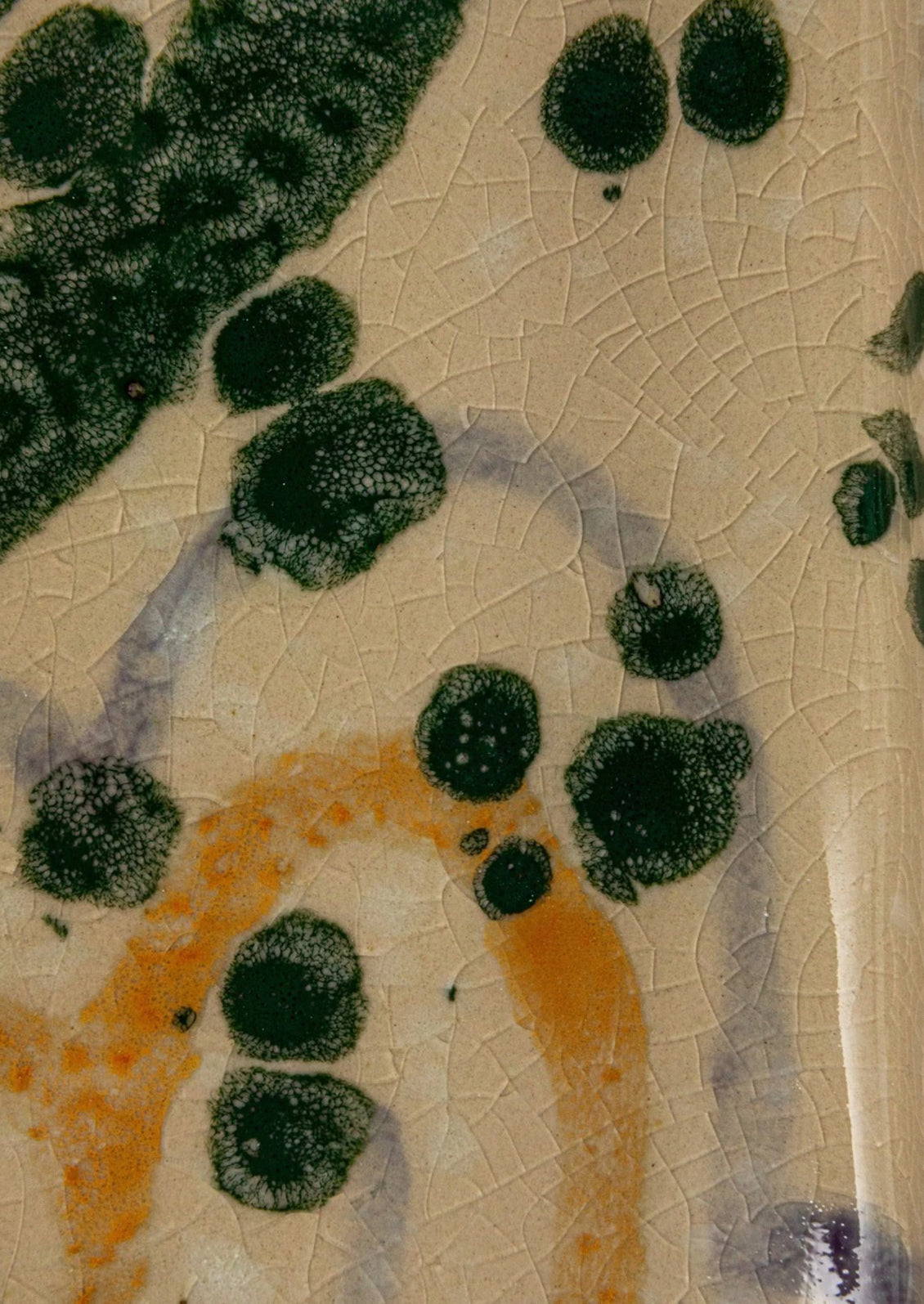 Multicolor splatter detail on ceramic.