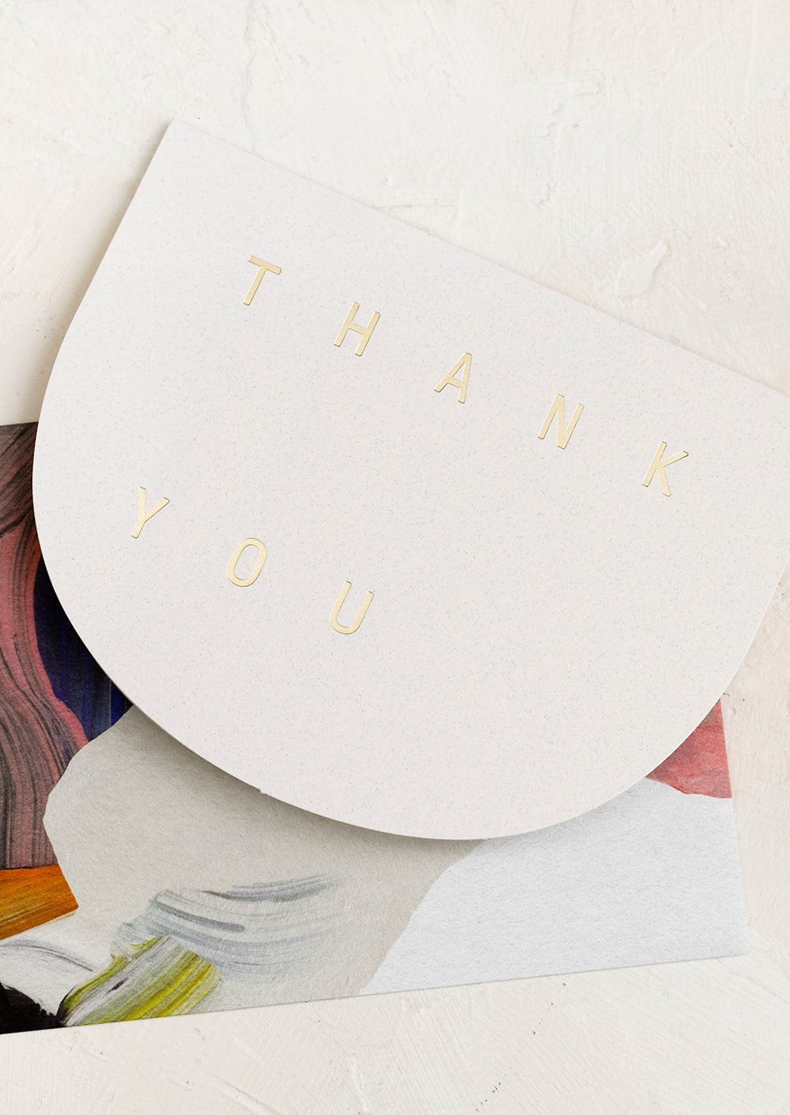 An arch shaped card reading "THANK YOU" in gold letters.