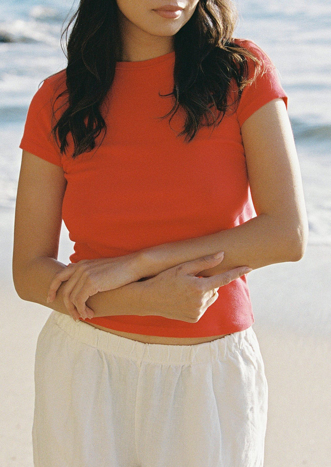 A woman wearing a red short sleeve tee.
