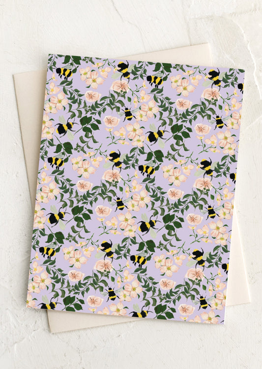 A greeting card in lavender with allover bumblebee floral print.