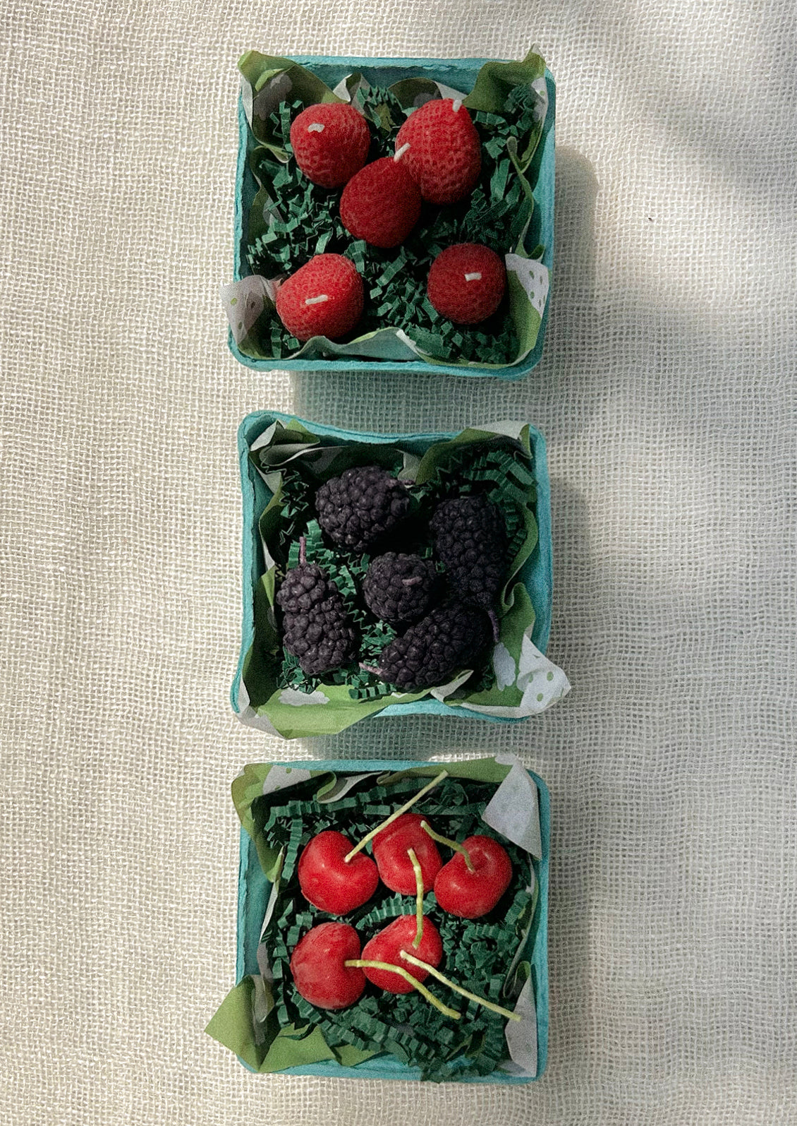 Berry shaped candles in berry cartons.