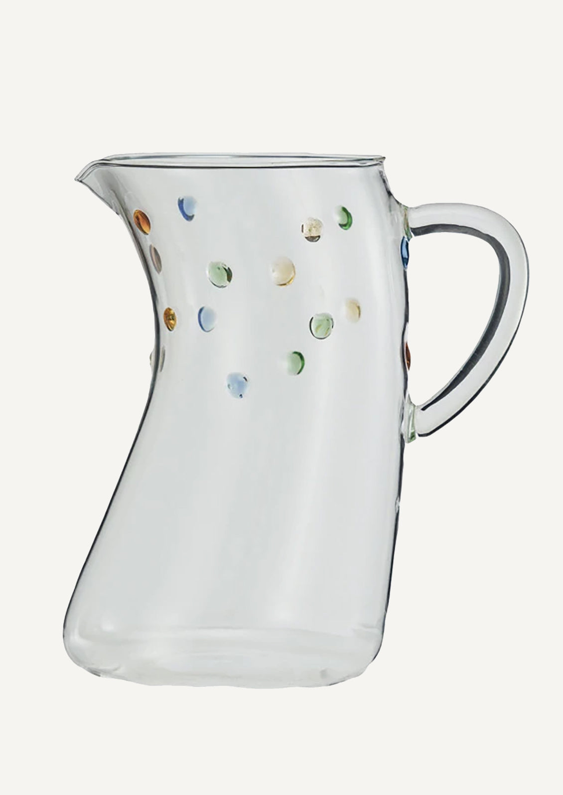 A skewed shape clear glass pitcher with colorful dot detail.