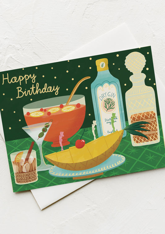 A card with illustration of liquor bottles and punch bowl, text reads "Happy Birthday".