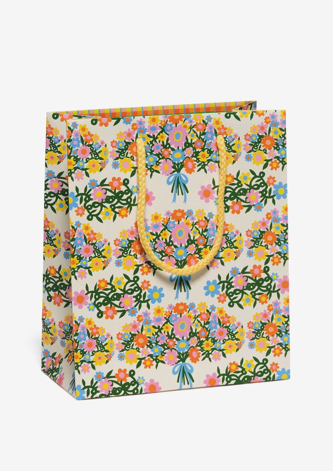 A printed gift bag with colorful bouquet print on cream background.