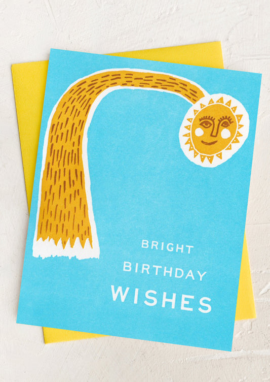 A blue card with illustration of sun, text reads "Bright birthday wishes".