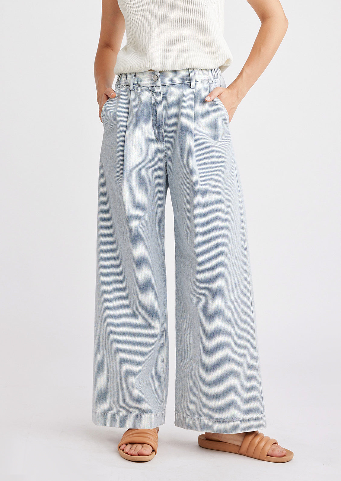 A pair of wide leg, pleat front denim pants in fine blue and white pinstripe.