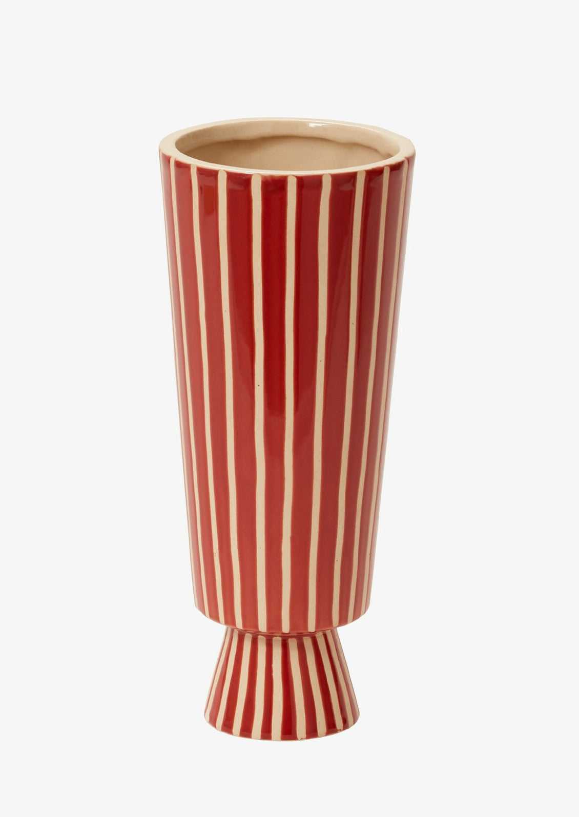 A tall and skinny vase with conical shape in red ceramic with vertical thin white stripes.