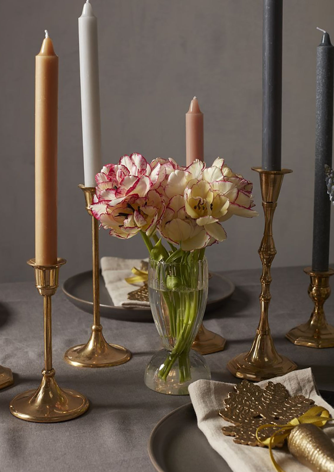 A glass vase with flowers on a table.