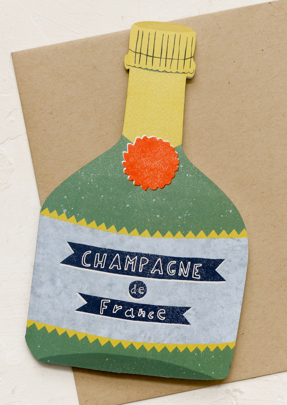 A diecut card in shape of champagne bottle.