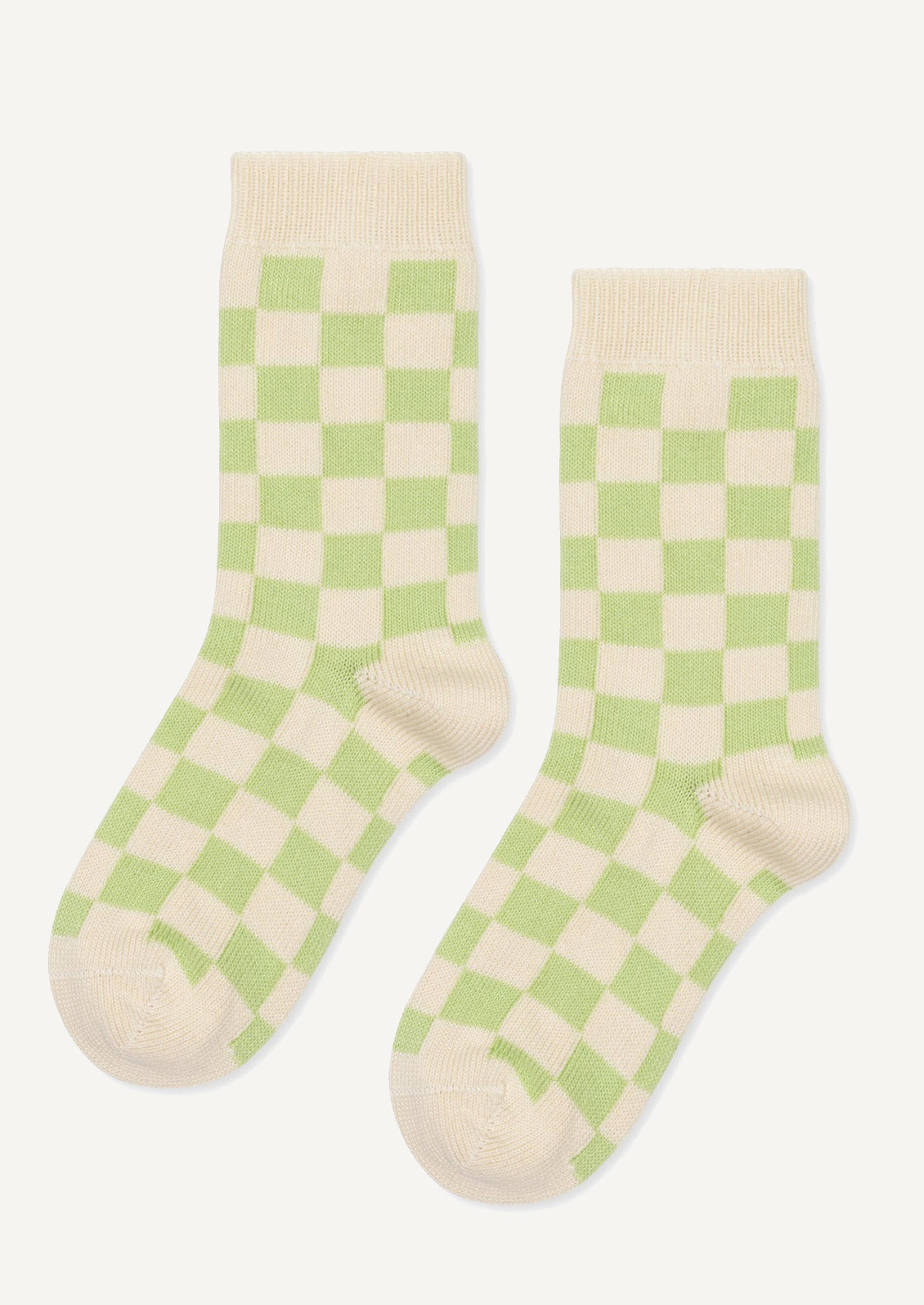 A pair of socks in green and cream checker.