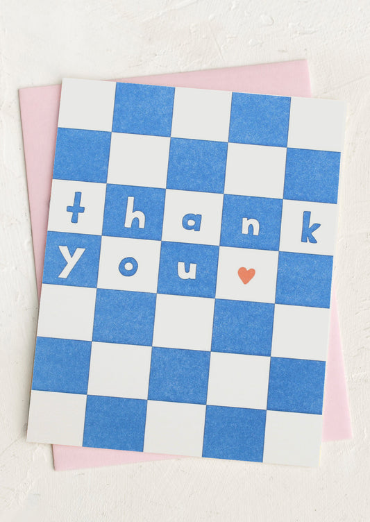 A blue checker print card with text reading "Thank You".