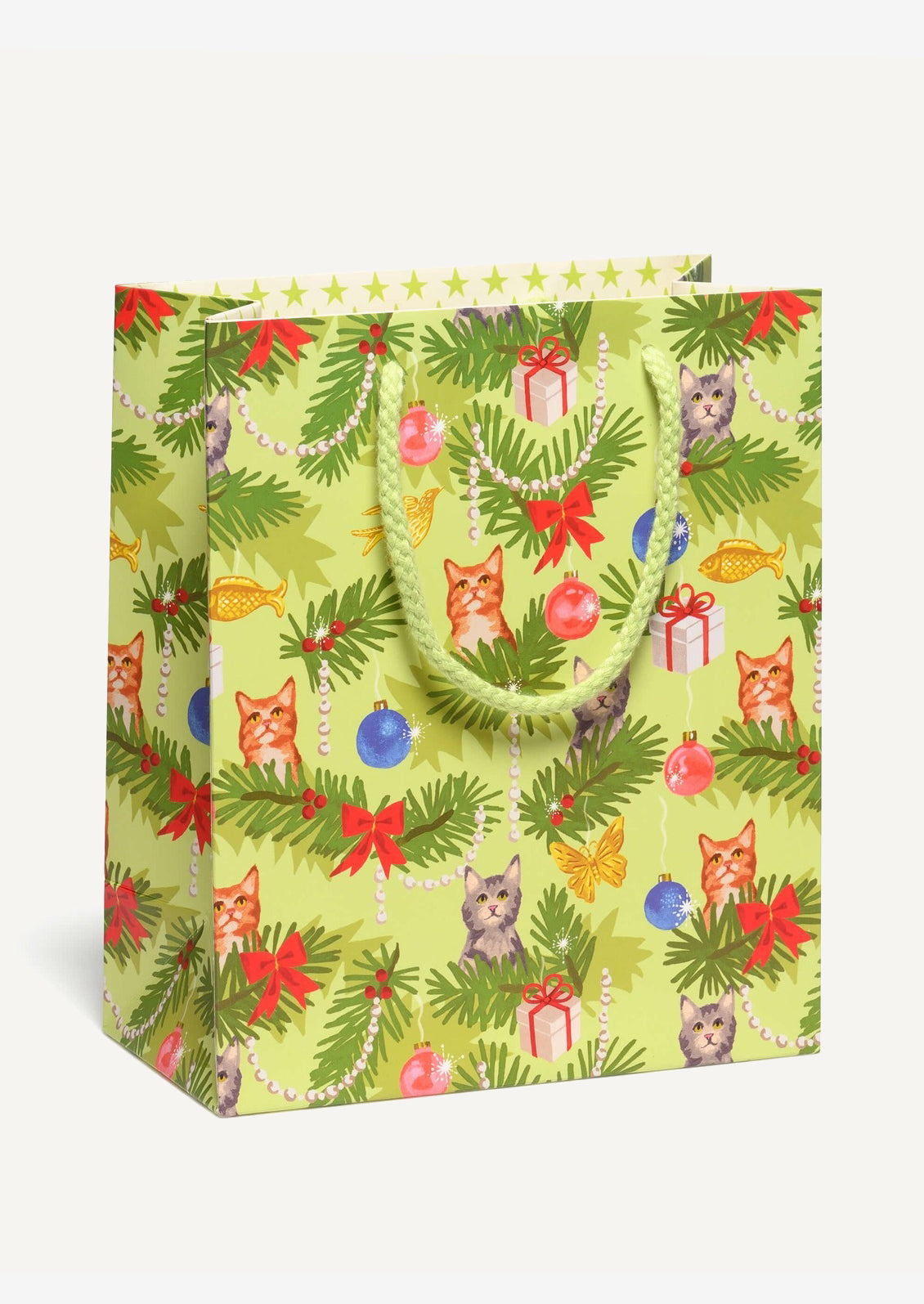 A medium printed gift bag in green with cats and Christmas tree print.