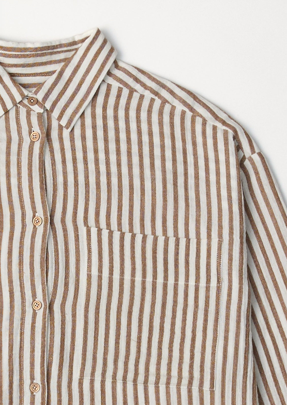 A white and brown stripe cotton gauze button down shirt.