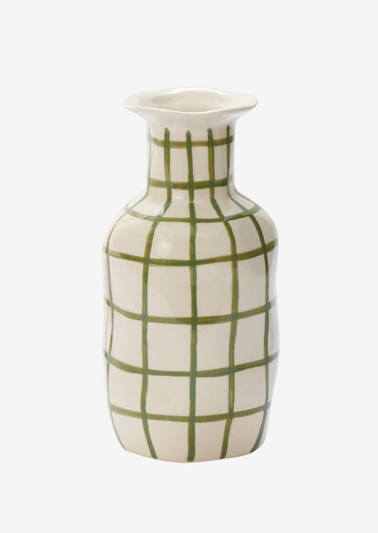 A ceramic vase in white with green grid pattern.