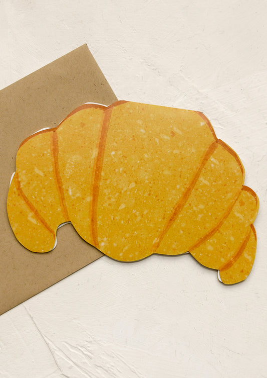 A diecut card in shape of croissant.