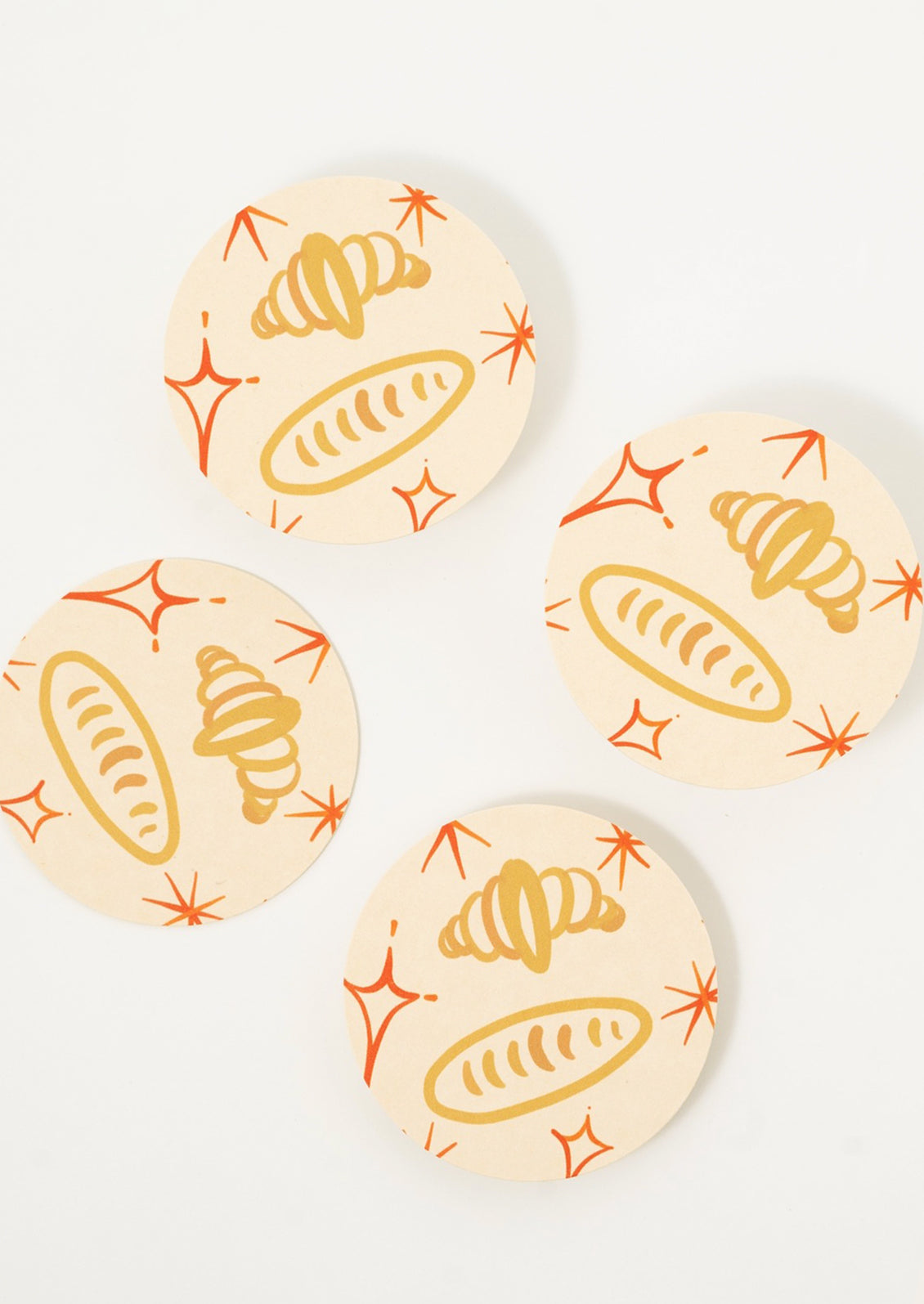 Paper coasters with bread and croissant print.