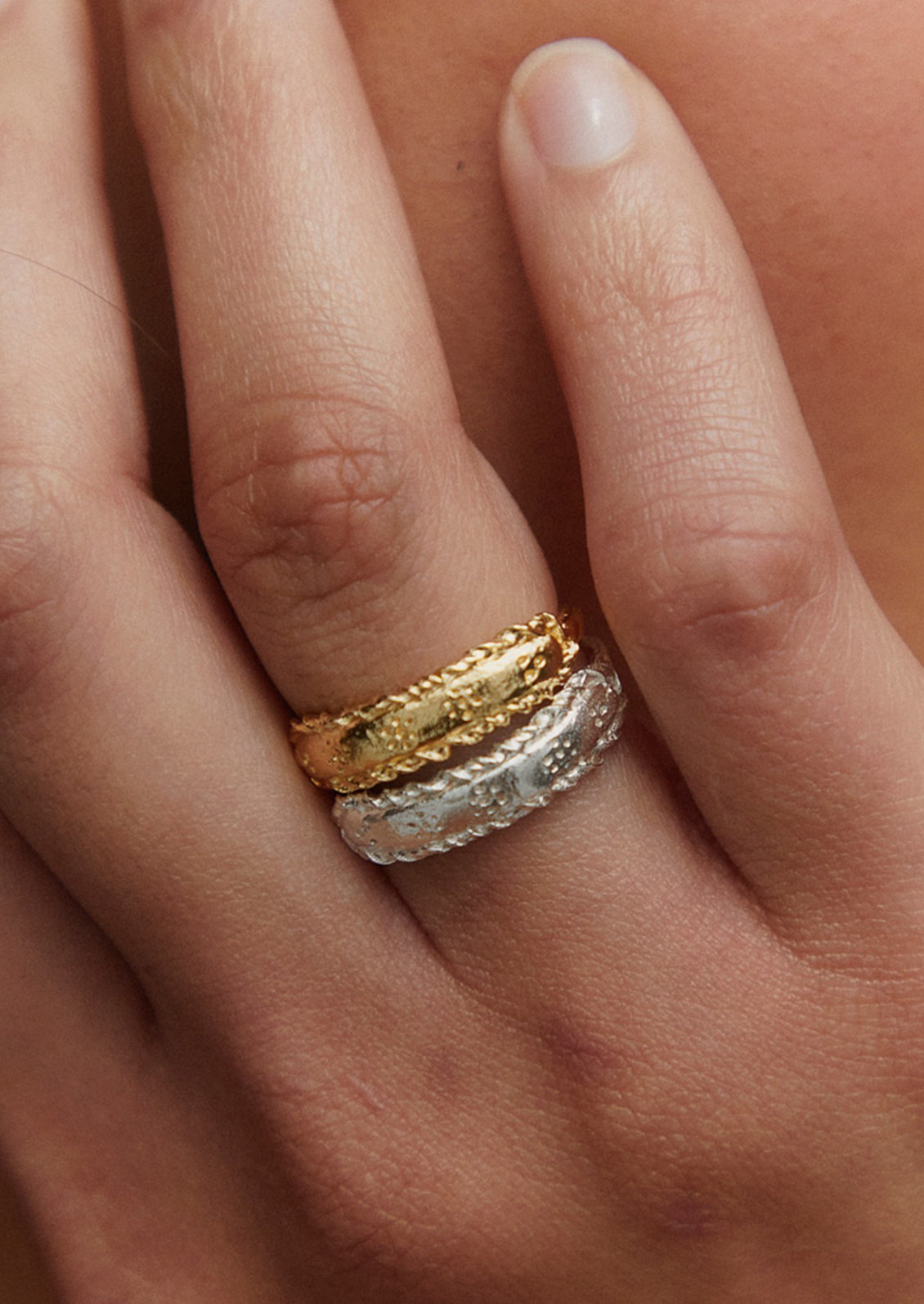 Gold and silver rings with delicate floral etching.