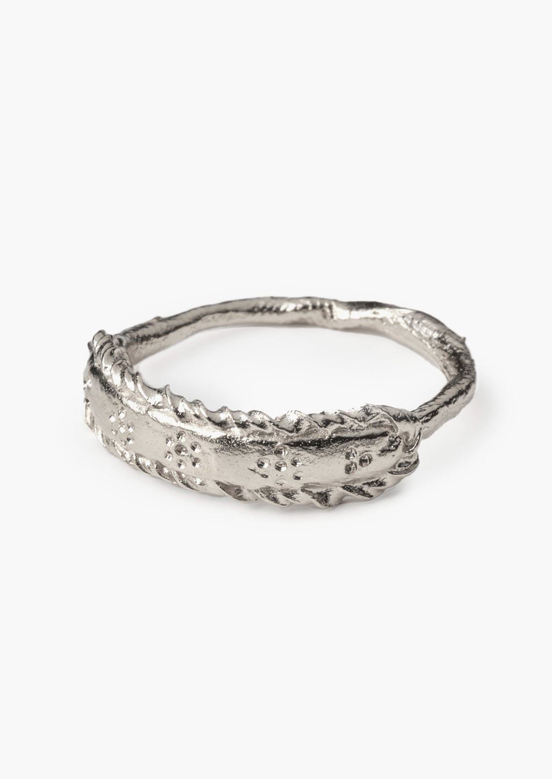 A silver ring with delicate floral etching.