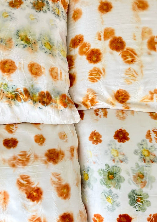 White silk pillowcases dyed in cosmos bundle dye pattern.