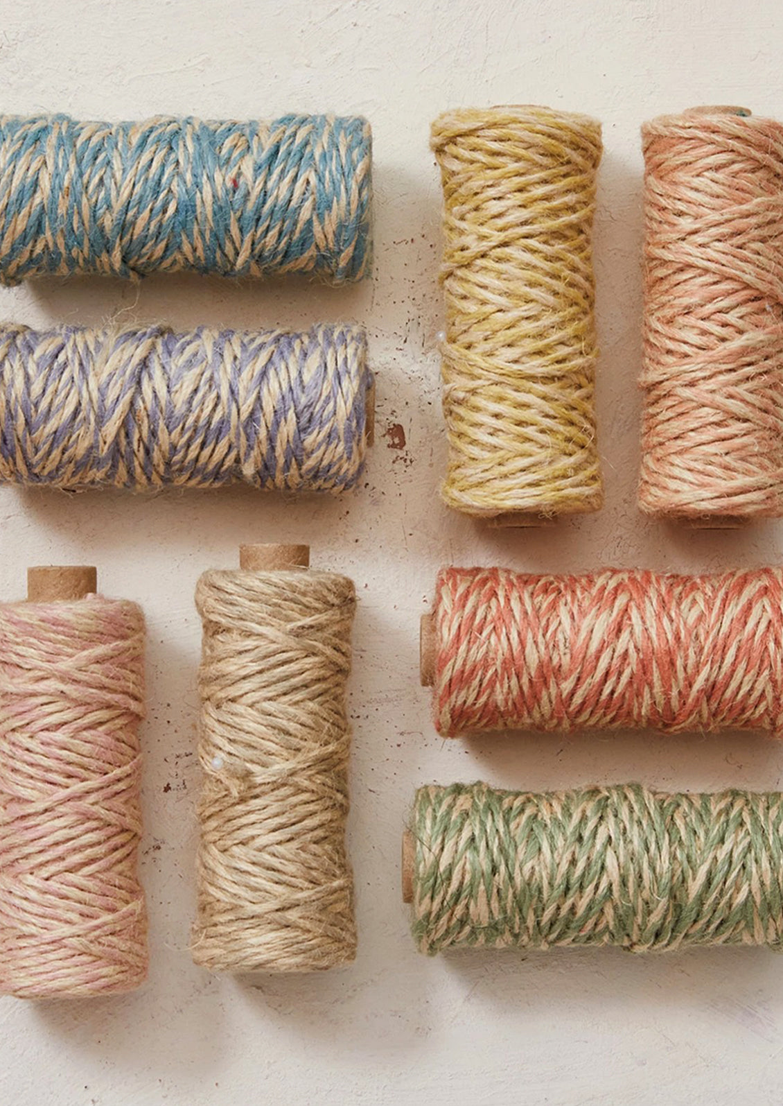 Two tone jute twine on spools in eight assorted colors.