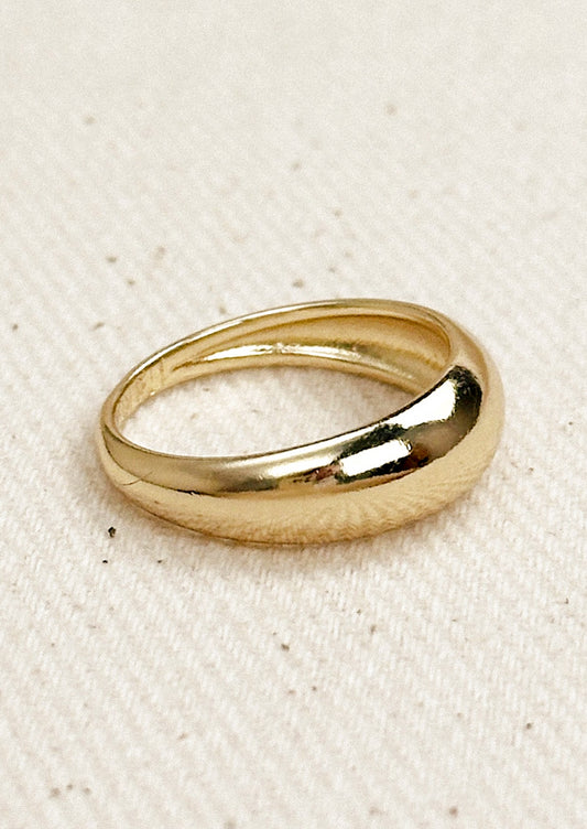 A gold ring with wide dome shaped front.