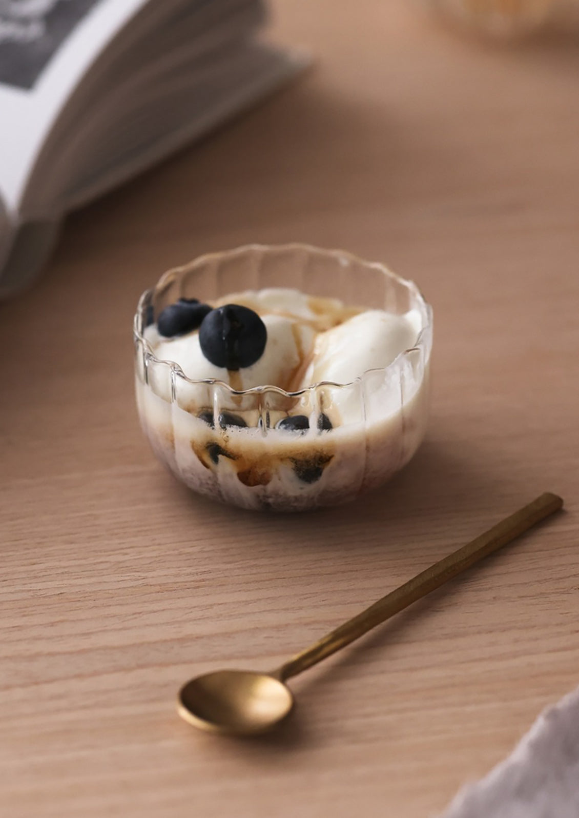 A small clear glass bowl with fluted texture.