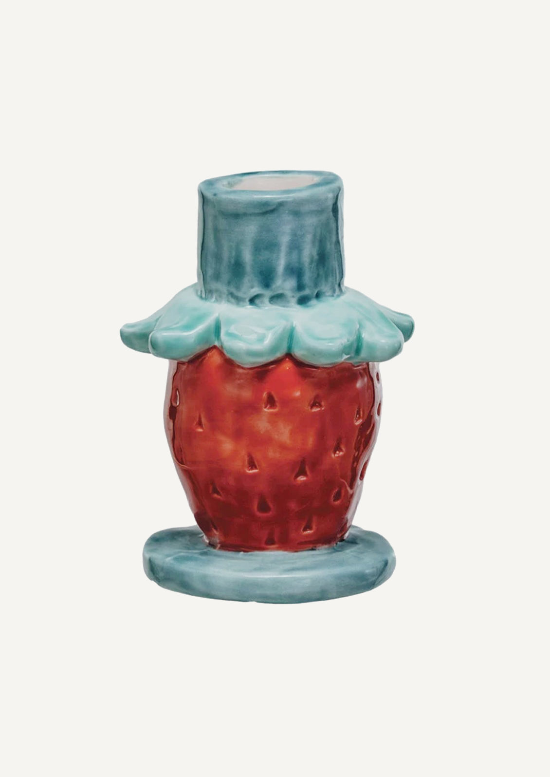 A ceramic candle holder with playful look, roughly in the shape of strawberry with decorative blue trim.