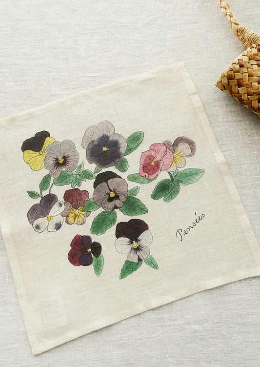 A linen handkerchief with screen printed pansies illustration.