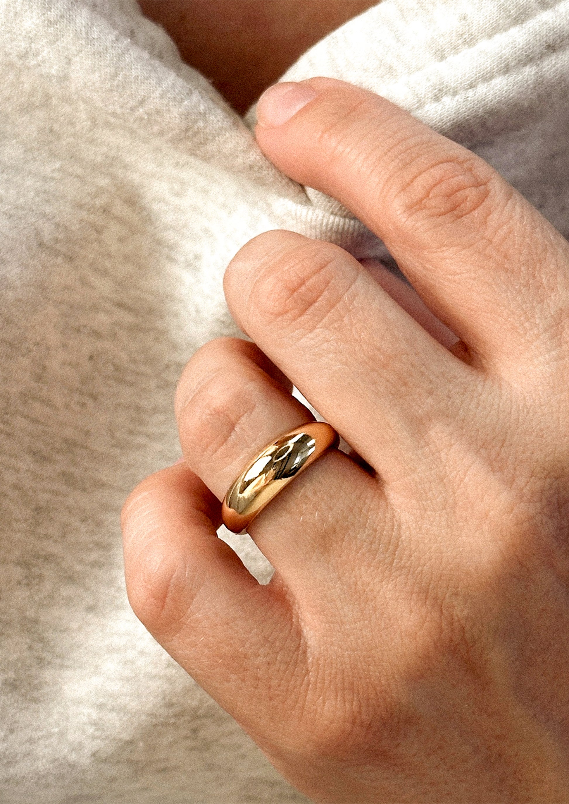 A gold ring with wide dome shaped front.