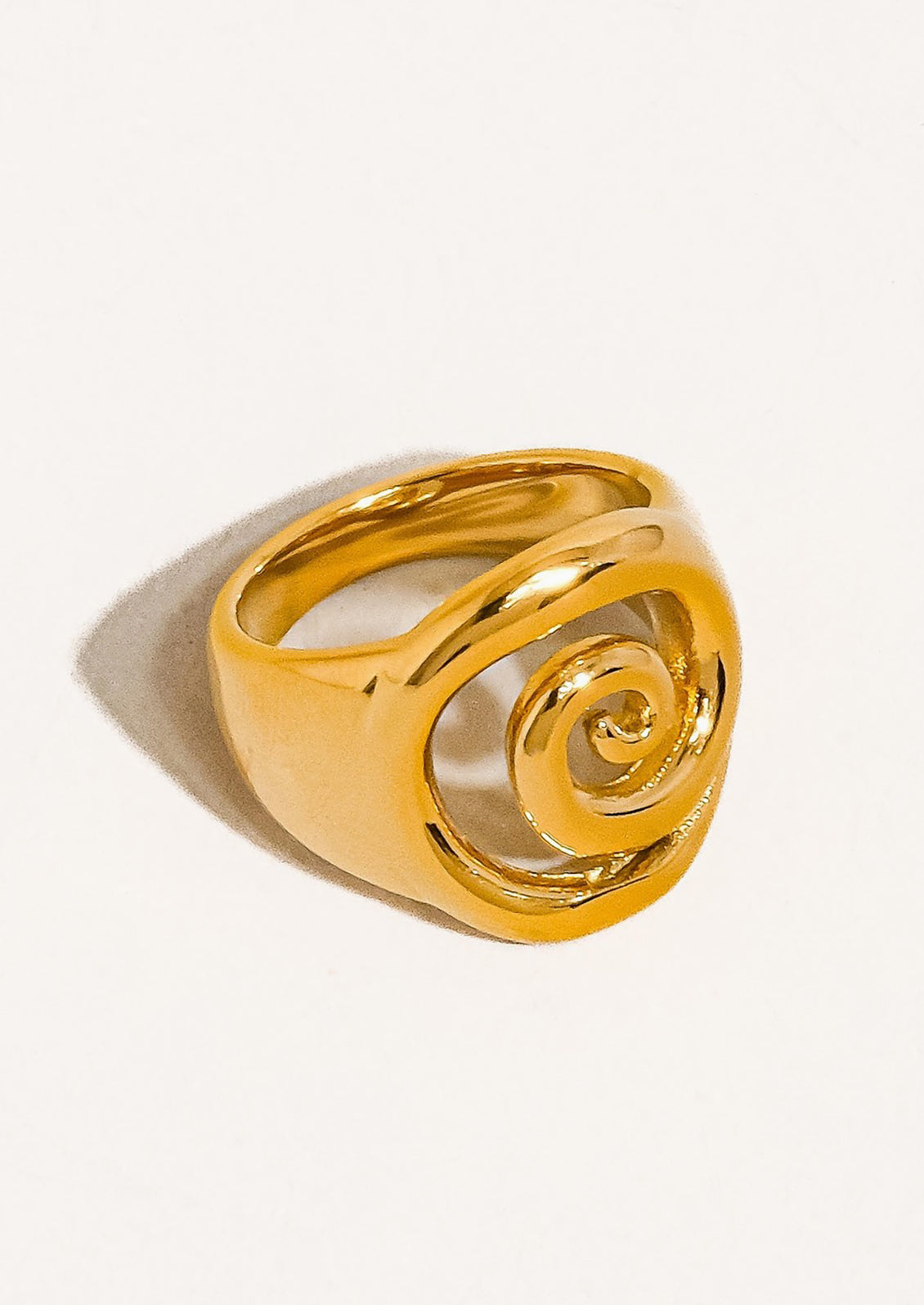 A swirl shaped ring in gold.