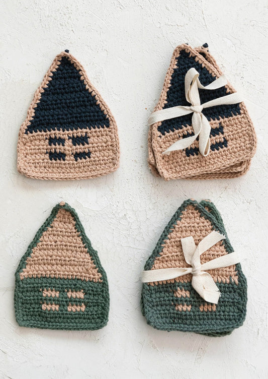 A set of four crocheted coasters in the shape of a house.