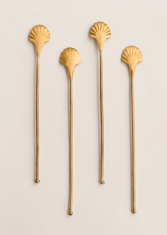 Seashell drink stirrers in solid brass.