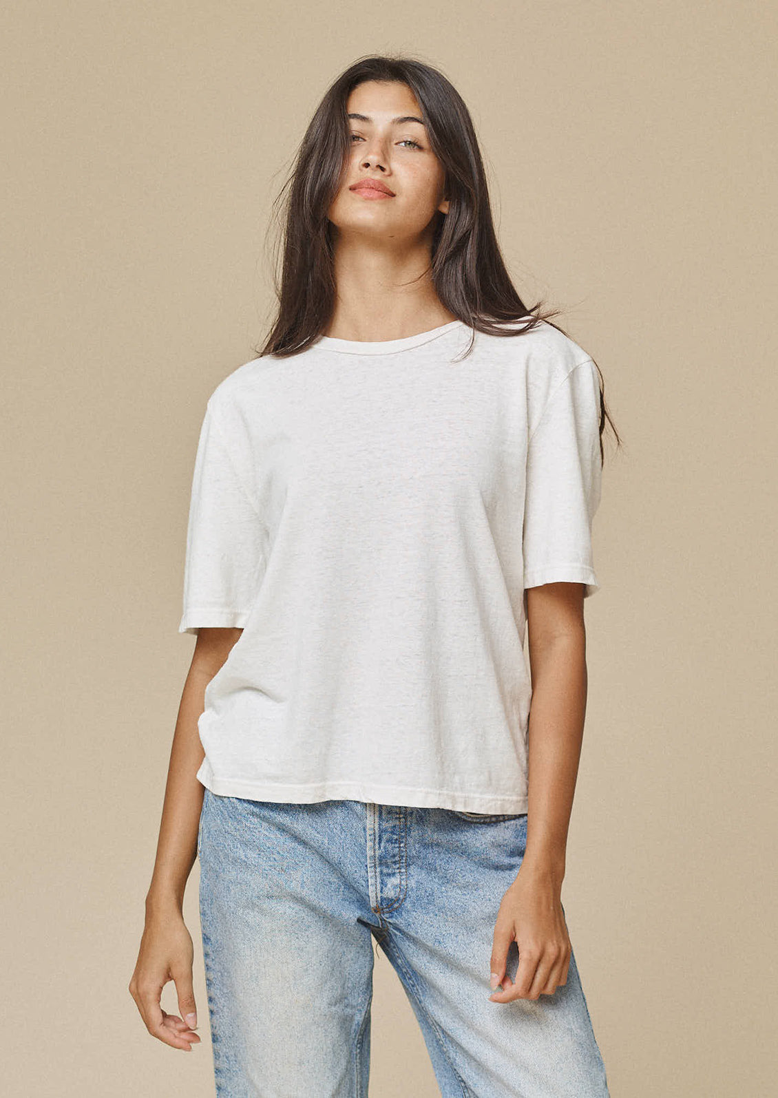 A woman wearing a relaxed hemp-cotton tshirt in white.