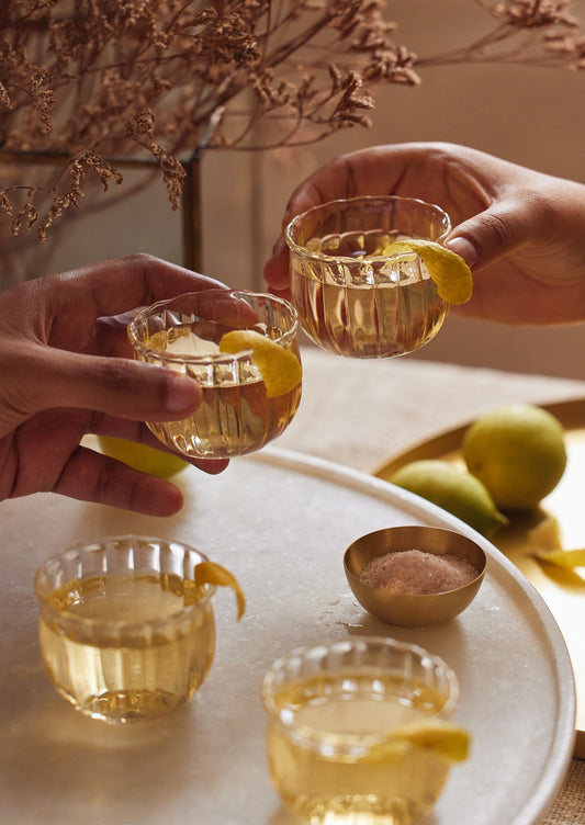 Small glass wine cups with fluted texture.