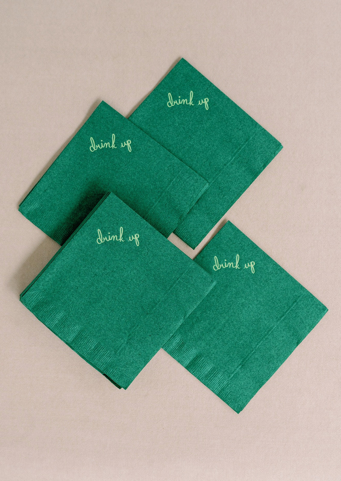 Green paper napkins reading "Drink up" at corner.