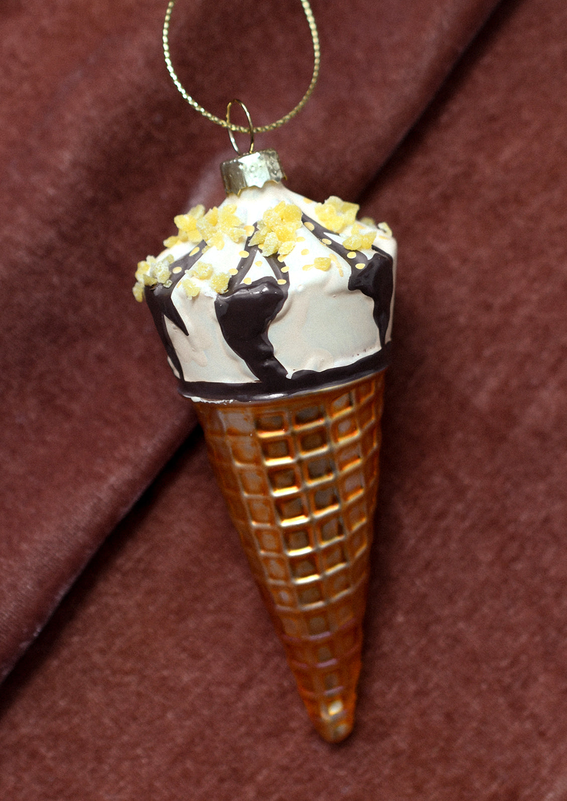 A glass ornament resembling a drumstick ice cream cone.