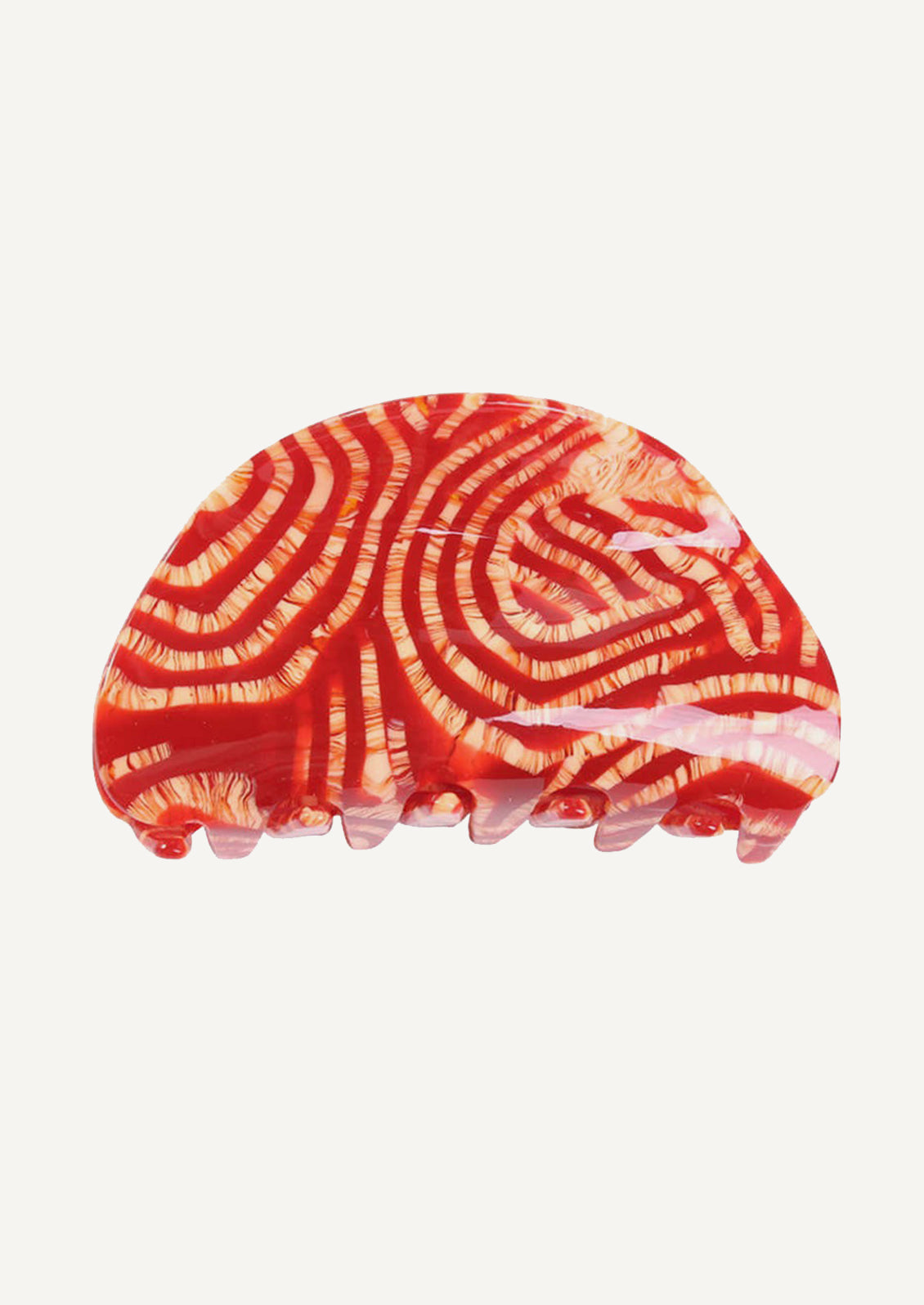 A curved hair claw in red and cream stripe pattern.