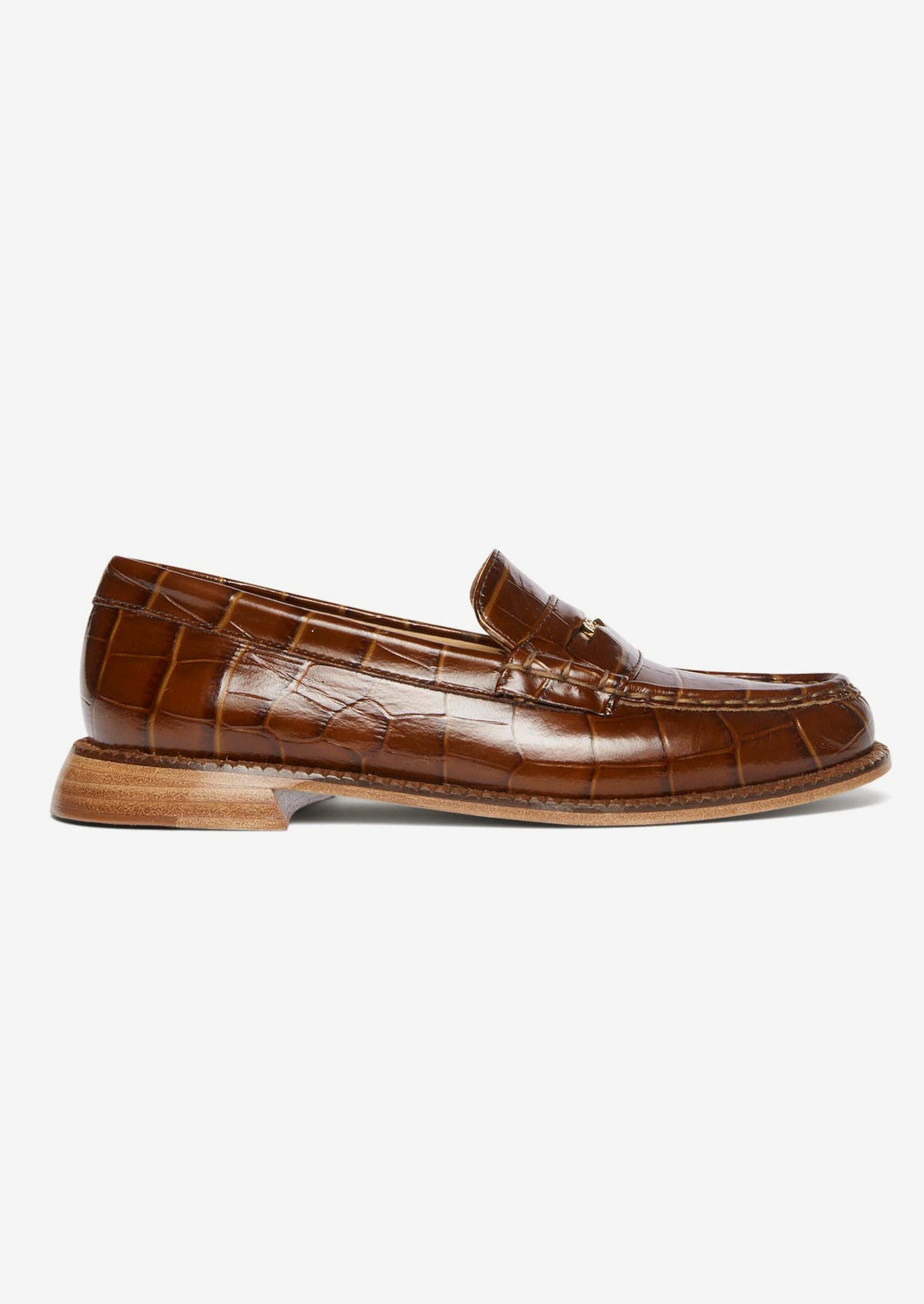 A pair of penny loafers in brown croc embossed leather.